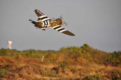 Low angle view of airplane flying against sky