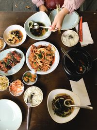 High angle view of person eating food on table