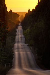 Road by mountain against sky