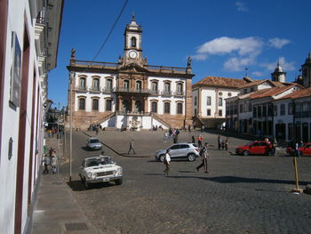 Vehicles on road by buildings in city