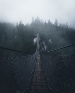 Footbridge in foggy weather at night