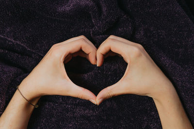 Close-up of woman hand holding heart shape