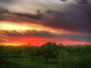 Scenic view of dramatic sky over landscape during sunset