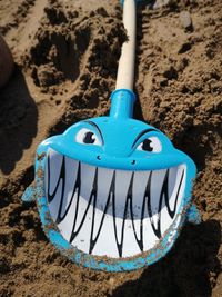 Close-up of blue toy on rock