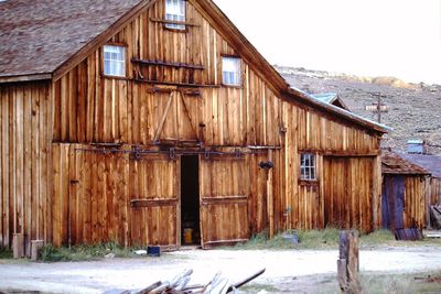 Old barn on building against sky