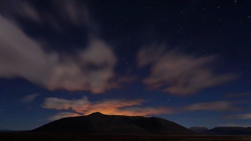 Scenic view of mountains against sky at night