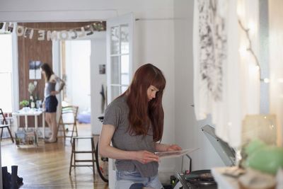 Young woman looking at a record album