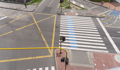 High angle view of yellow crossing sign on road