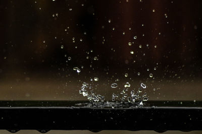 Close-up of water drops on star field against sky at night