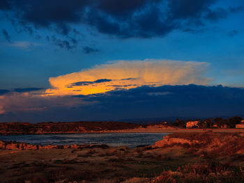 Scenic view of beach against sky during sunset