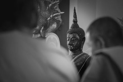 Statue of buddha against building