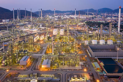 Oil refinery and gas petrochemical industry with storage tanks steel pipeline area at twilight 