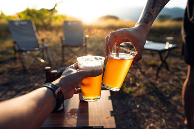 Cropped hand of woman holding drink