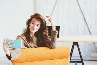 Portrait of young woman using mobile phone