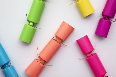 High angle view of colorful bottles against white background