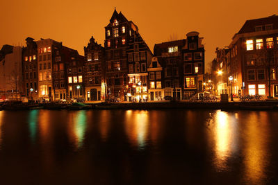 Reflection of buildings in city at night