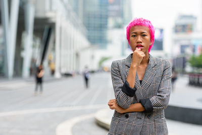 Portrait of beautiful young woman in city