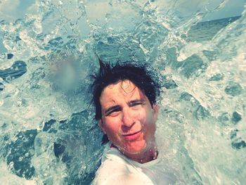 Portrait of young woman in water