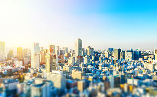 Aerial view of modern buildings in city against sky