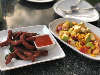 High angle view of serving meat in plate on table