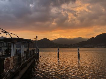 Sailboats in sea against sky during sunset