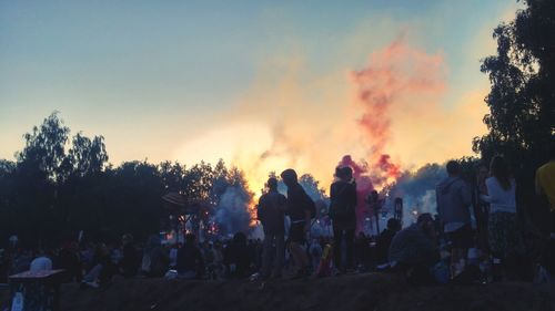 Crowd against sky during sunset