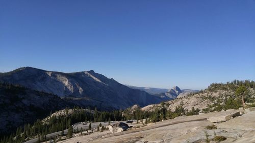 Scenic view of mountains against clear blue sky
