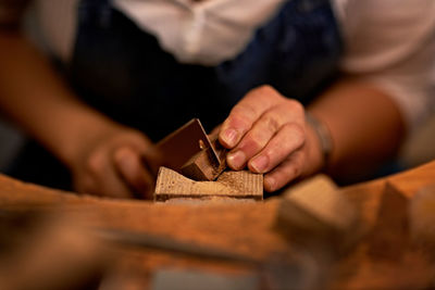 Midsection of man working at workshop