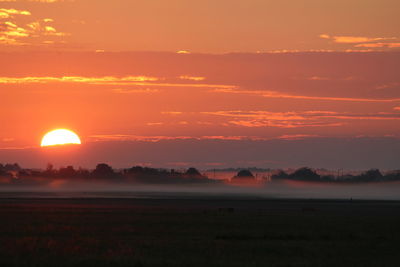 Scenic view of sunset over land