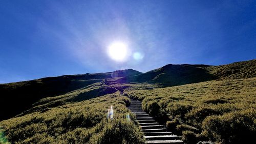 Scenic view of mountains against blue sky