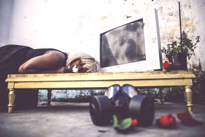 Woman sleeping on bed outdoors