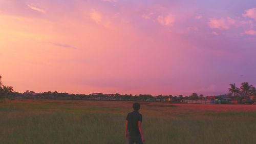 Woman standing on grassy field