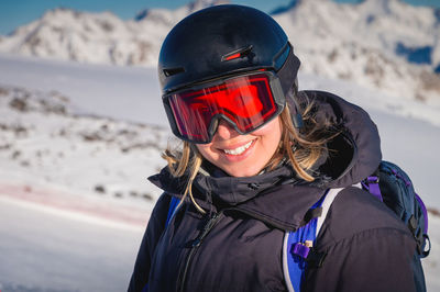 Woman with a beautiful smile in a ski helmet. portrait of a female skier in a safe ski helmet and