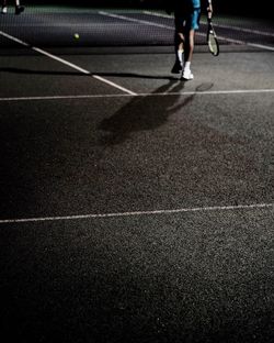 Low section of man walking on zebra crossing