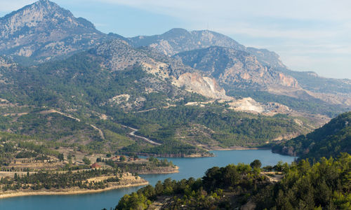 Scenic view of river and mountains against sky