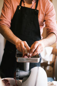 Midsection of man preparing food