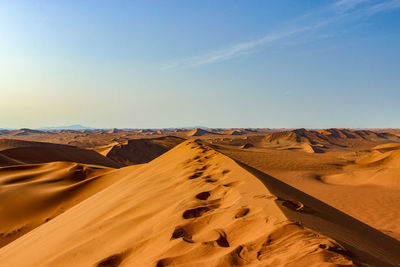 Scenic view of desert against clear sky