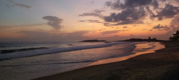 Scenic view of beach against sky during sunset