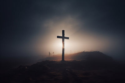 Cross in the fog on the morning mountain