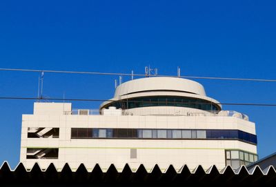 Low angle view of building against clear blue sky