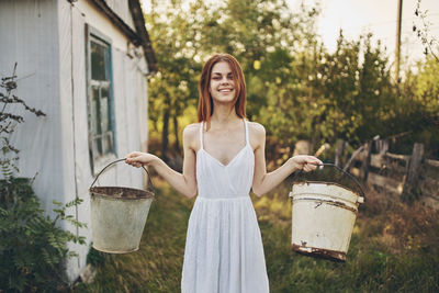 Happy woman standing against the wall