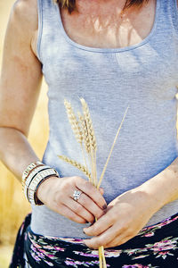 Woman holding blades of wheat