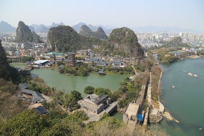 High angle view of river and cityscape against sky