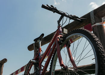 Low angle view of bicycle wheel against clear sky