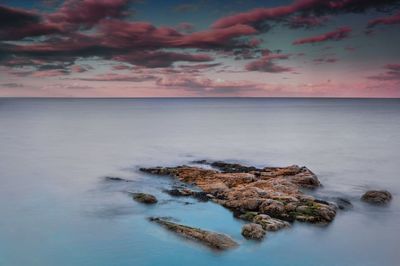 Scenic view of sea against sky at sunset