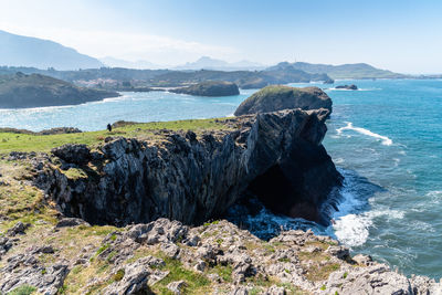 Scenic view of rocks in sea against sky