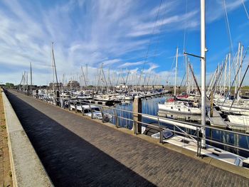 Sailboats moored at harbor