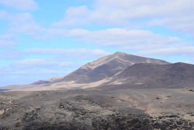 Scenic view of arid landscape against sky