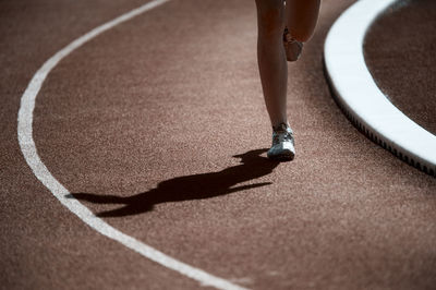 Low section of person running on road