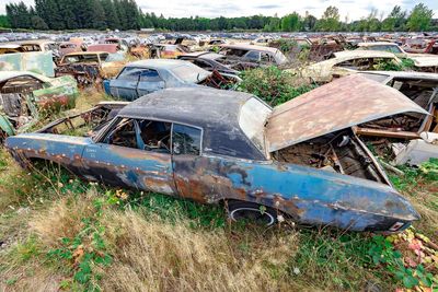 Abandoned car on field